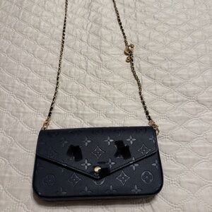 Chic Black Crossbody Bag with adjustable Gold Chain.